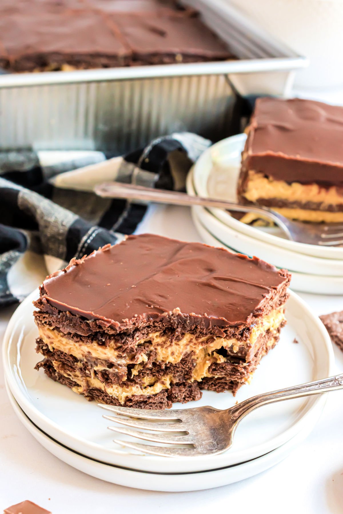 Slice of peanut butter icebox cake with a bite taken out.