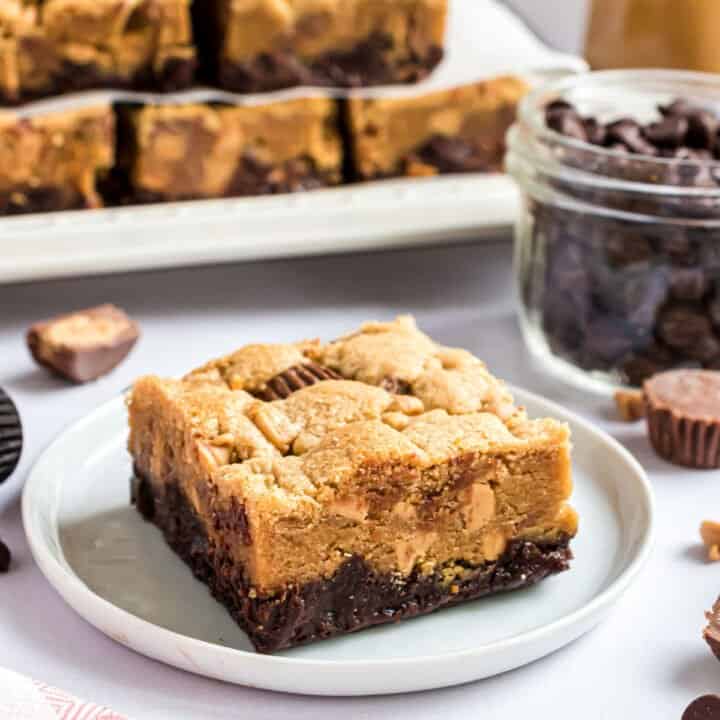 Peanut butter brookies on white plate with stack behind.