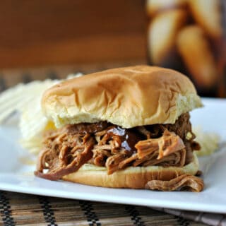 A slow cooker and a handful of ingredients are all you need to make Root Beer Pulled Pork. This tender fall-apart pork is begging to be piled onto buns and served with coleslaw! You'll love this flavorful BBQ inspired meal.