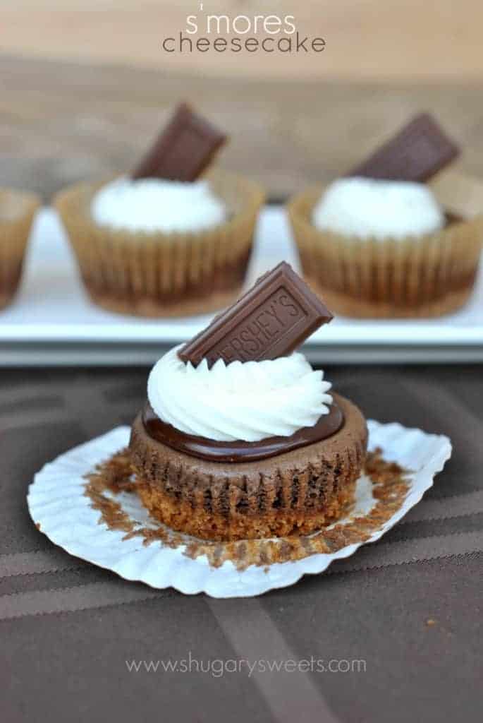 S'mores Cheesecakes: individual cheesecakes topped with chocolate ganache, marshmallow frosting and Hersheys!