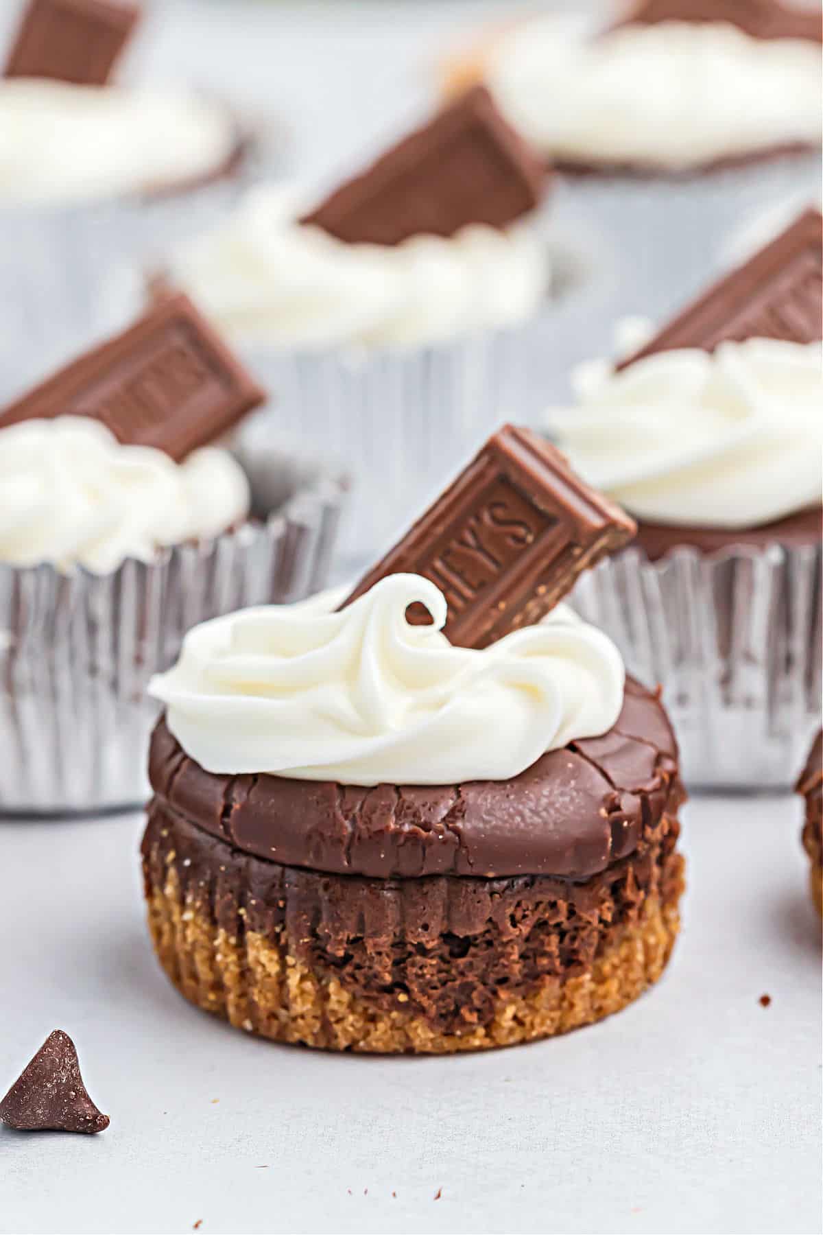 Mini cheesecakes with chocolate ganache and marshmallow frosting.
