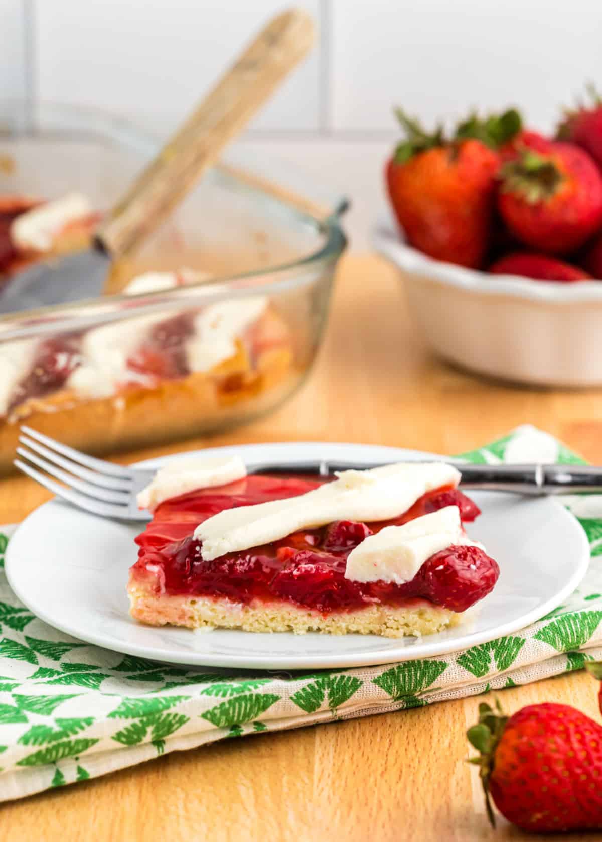 Strawberry pie bars served on a white plate.