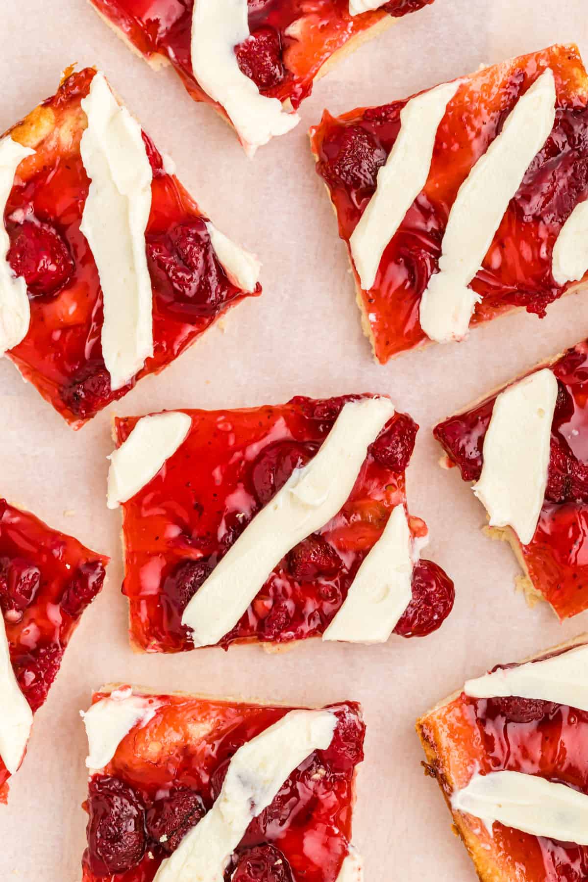 Slices of strawberry pie bars on white platter.