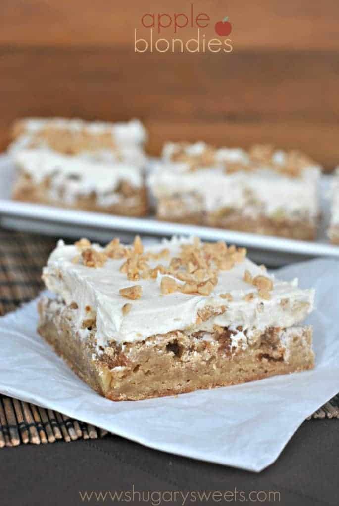 Square of apple bar topped with frosting and toffee bits.