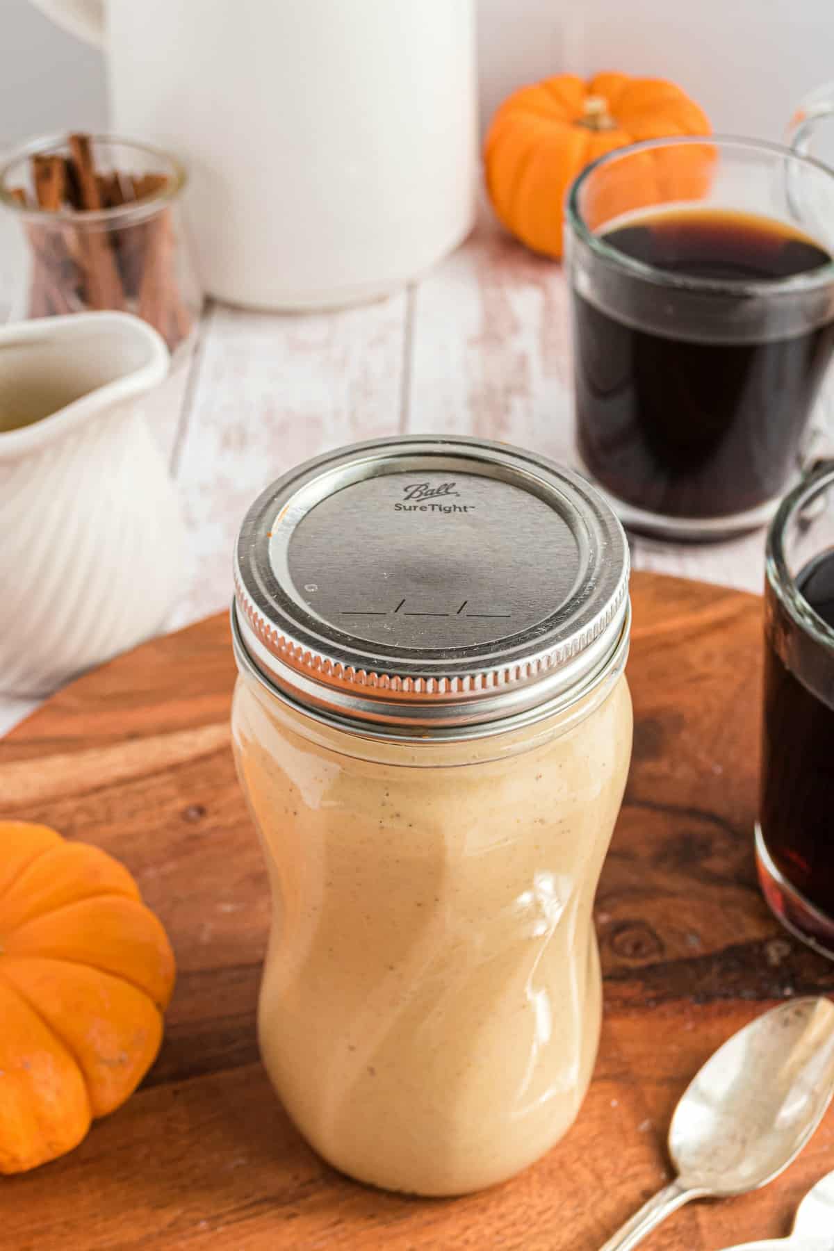 Mason jar filled with pumpkin spice creamer.