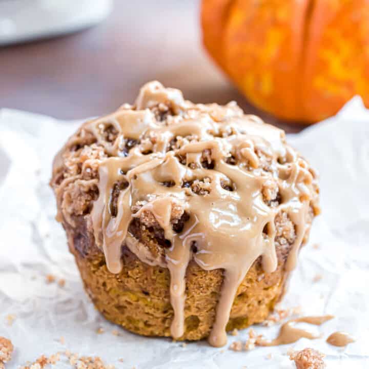 Maple glazed pumpkin muffins on parchment paper.