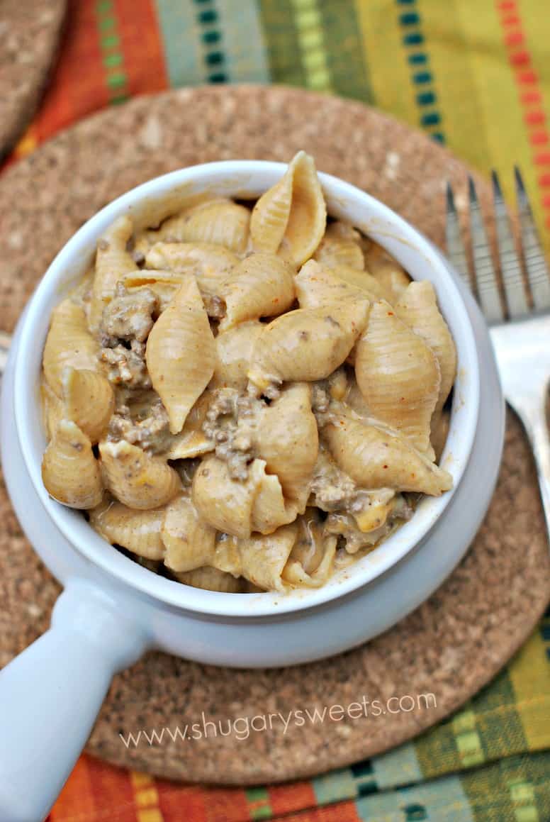 Beef enchilada mac and cheese shells in a white soup bowl.