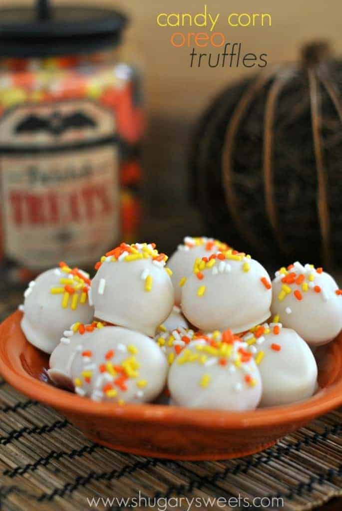 Truffles made with candy corn oreos dipped in white chocolate and decorated for Halloween.