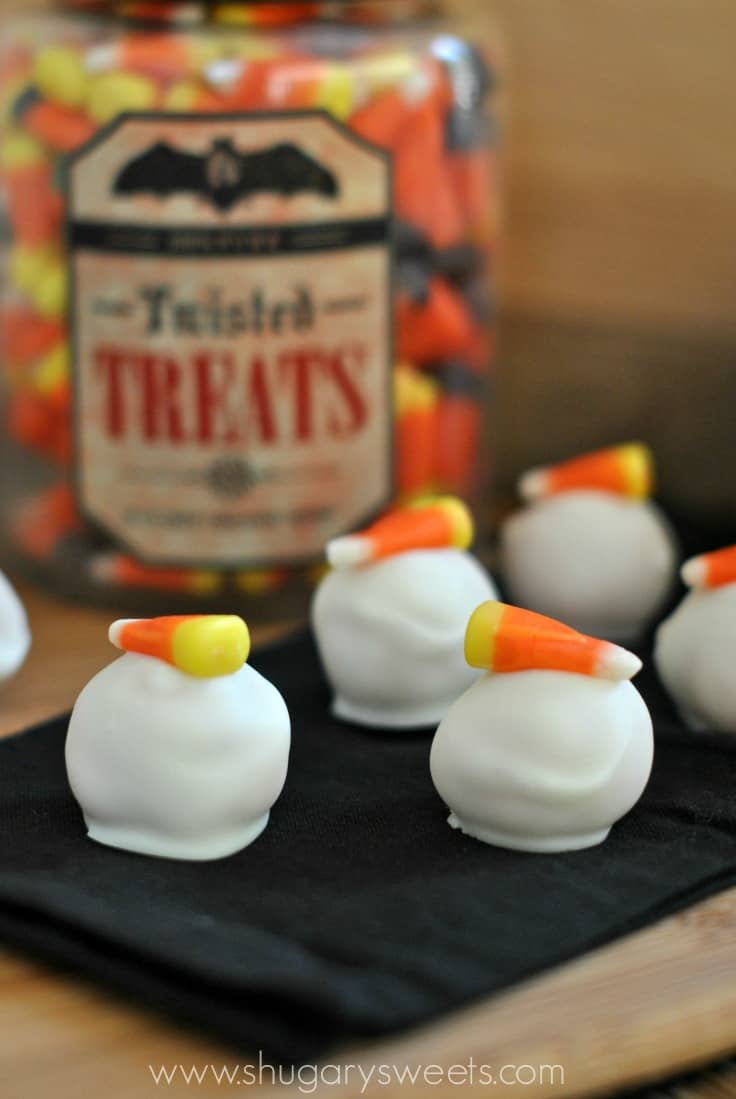 Halloween Oreo balls dipped in white chocolate and topped with a piece of candy corn.