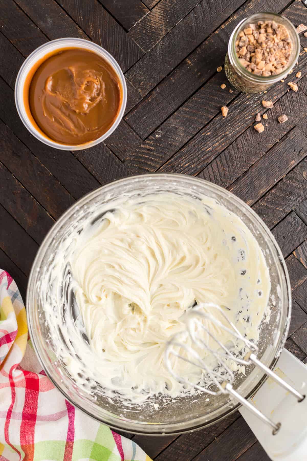 Cream cheese in a clear glass mixing bowl.
