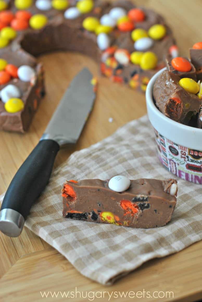 Slice of halloween fudge with oreos, candy corn, and m&m's.