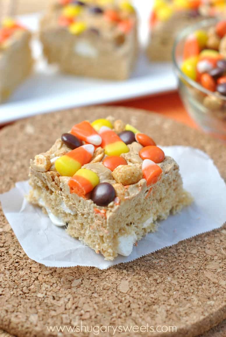 Peanut Butter Krispie Treats cut into a square and topped with M&M's, candy corn, and peanuts.