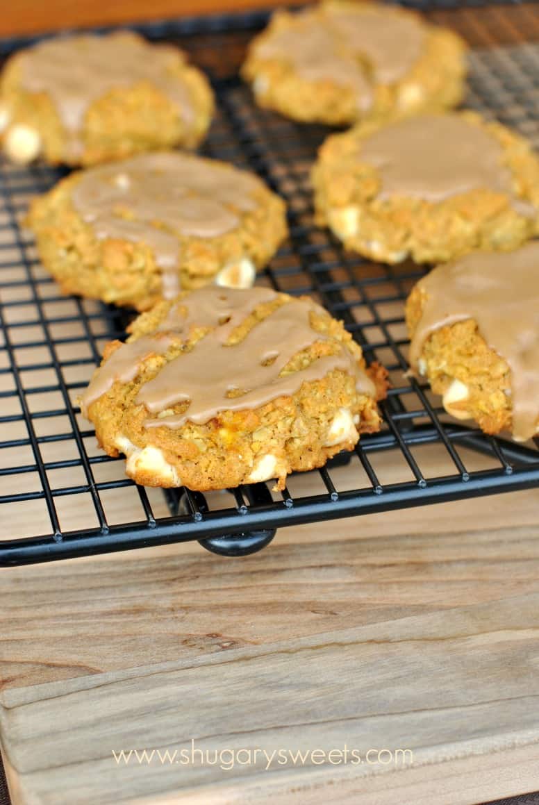 WIre rack with pumpkin cookies topped with maple glaze.