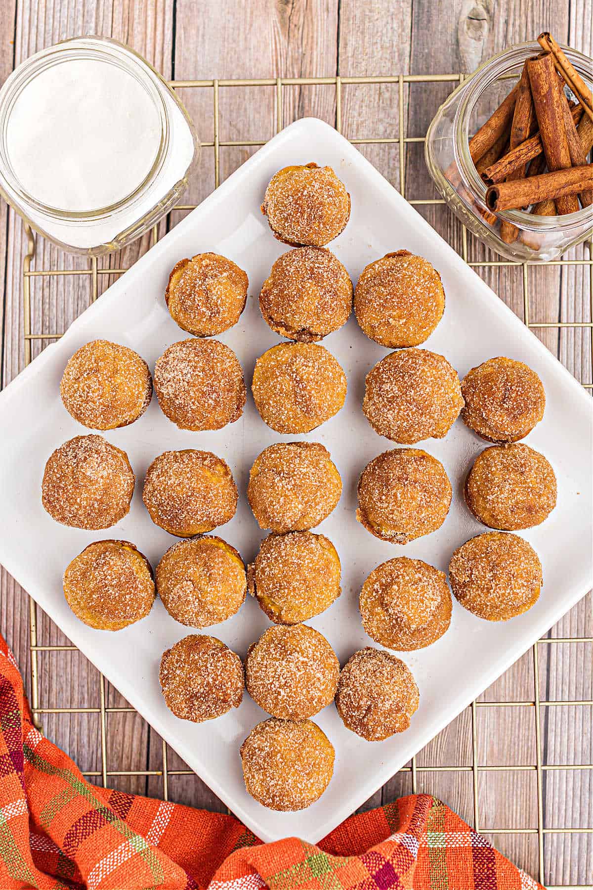 White platter with mini pumpkin donut holes.