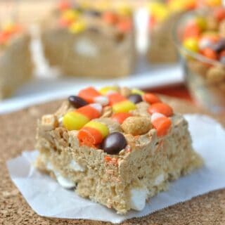 Chewy Peanut Butter Krispie treats topped with Candy Corn, Peanuts, and Reese's Pieces. This adaption of everyone's favorite childhood treat is here just in time for Halloween!