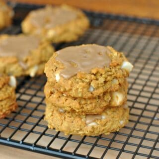 Stack of three pumpkin cookies with maple icing.