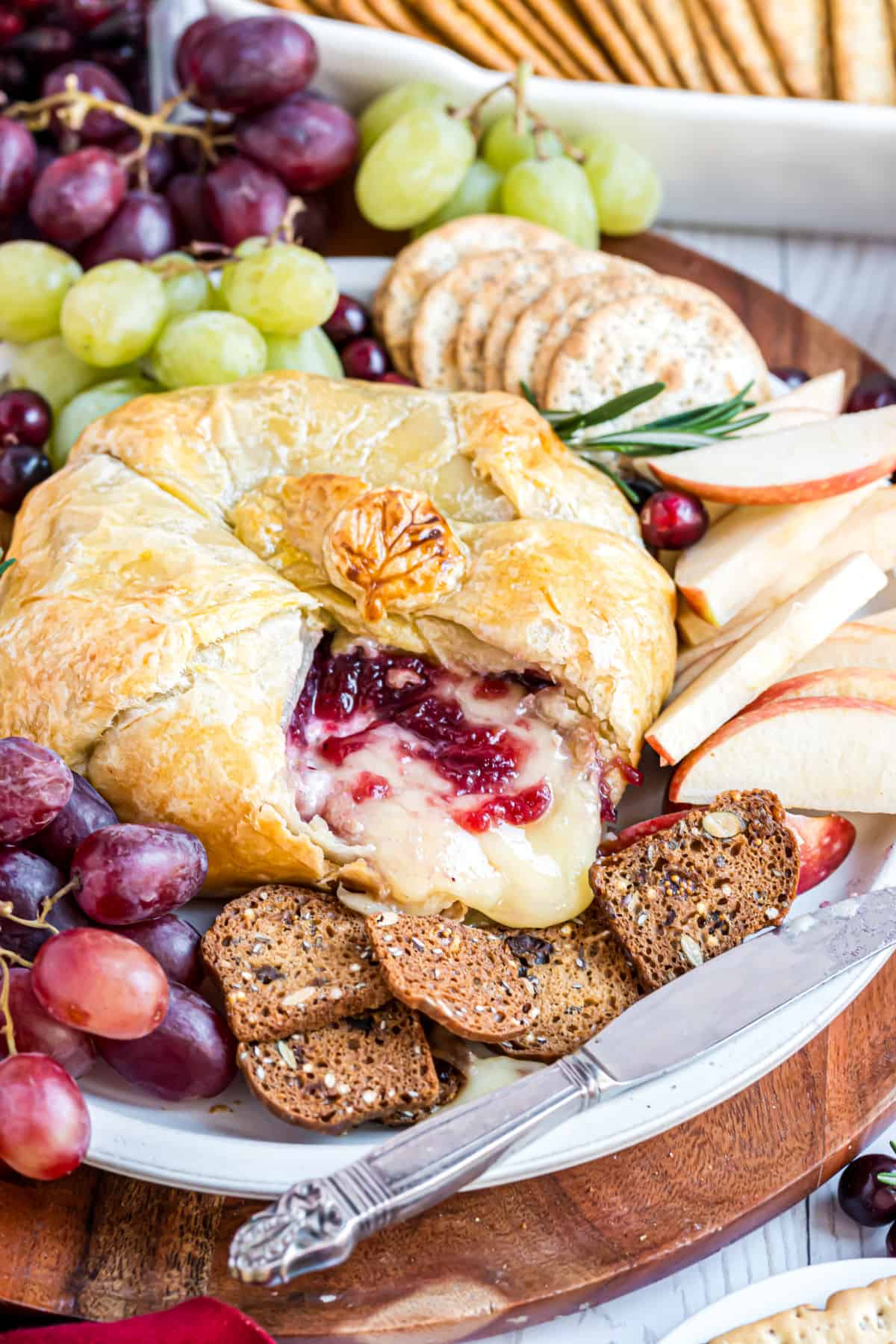 Baked brie wrapped with puff pastry and packed with cranberries and pecans.