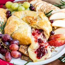 For the perfect Holiday appetizer, consider making this Cranberry Pecan Brie wrapped in Puff Pastry Sheets! Baked Brie is the elegant and easy party food you can make for all occasions.
