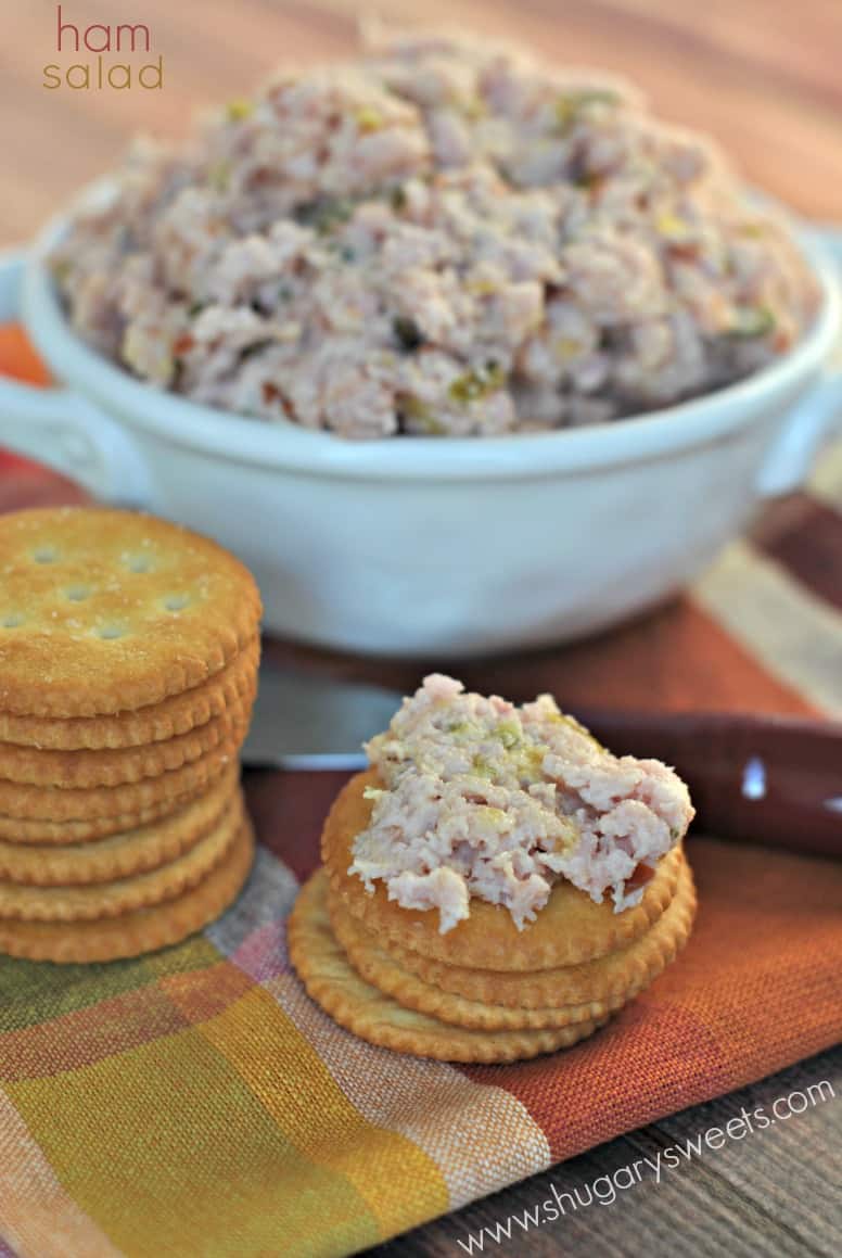 Ham salad in a white bowl served on a stack of ritz crackers.