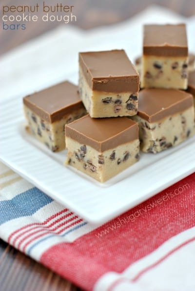 Stack of peanut butter cookie dough bars cut into small squares.