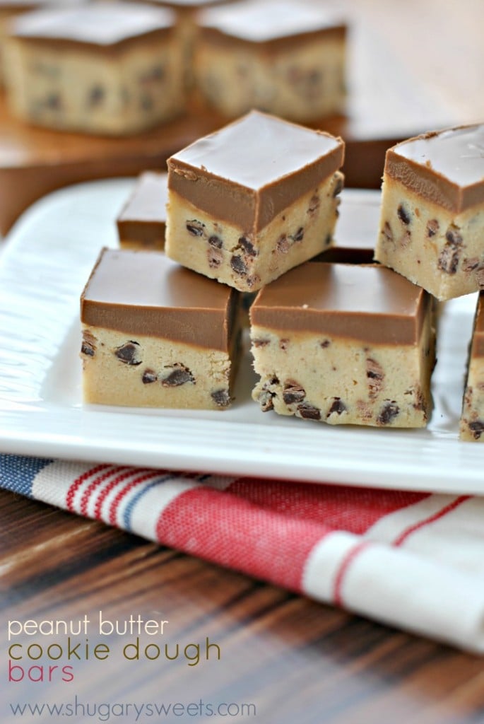 Stack of peanut butter cookie dough bars on a white plate.