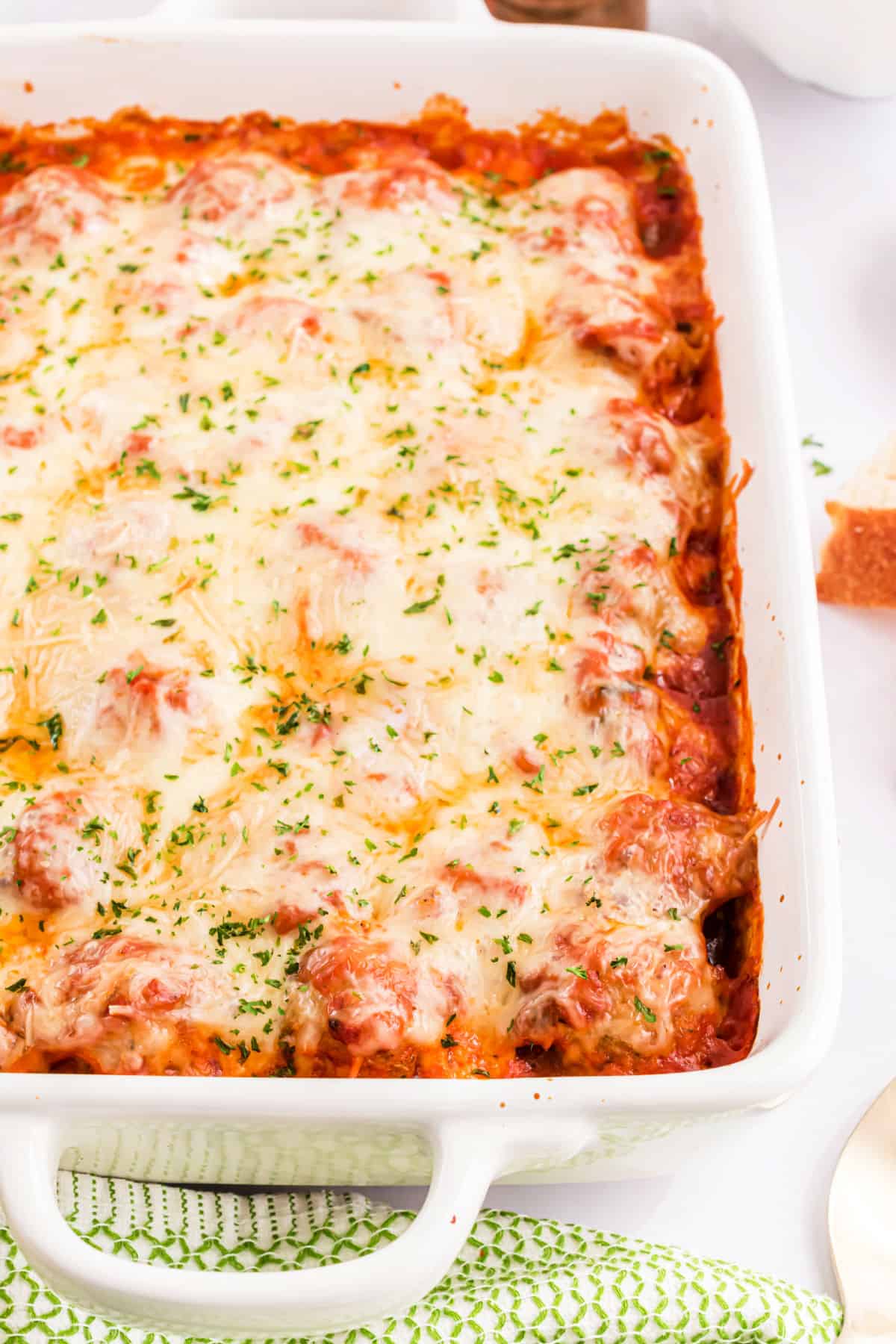 Baked meatball casserole in a white baking dish.