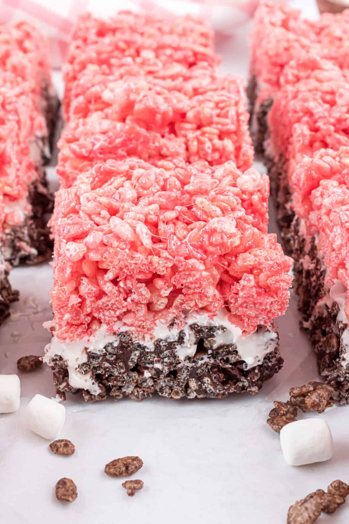 Neapolitan krispie treats on parchment paper.