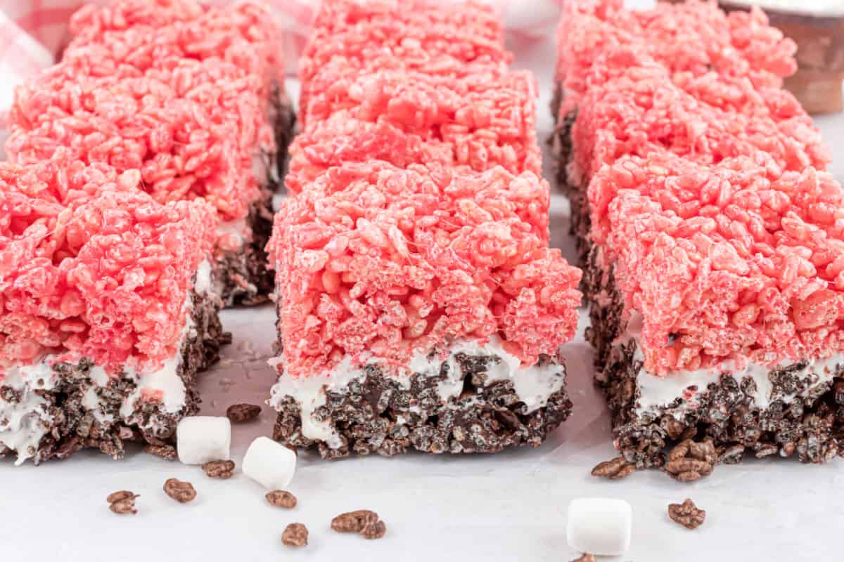 Strawberry and chocolate krispie treats on parchment paper.