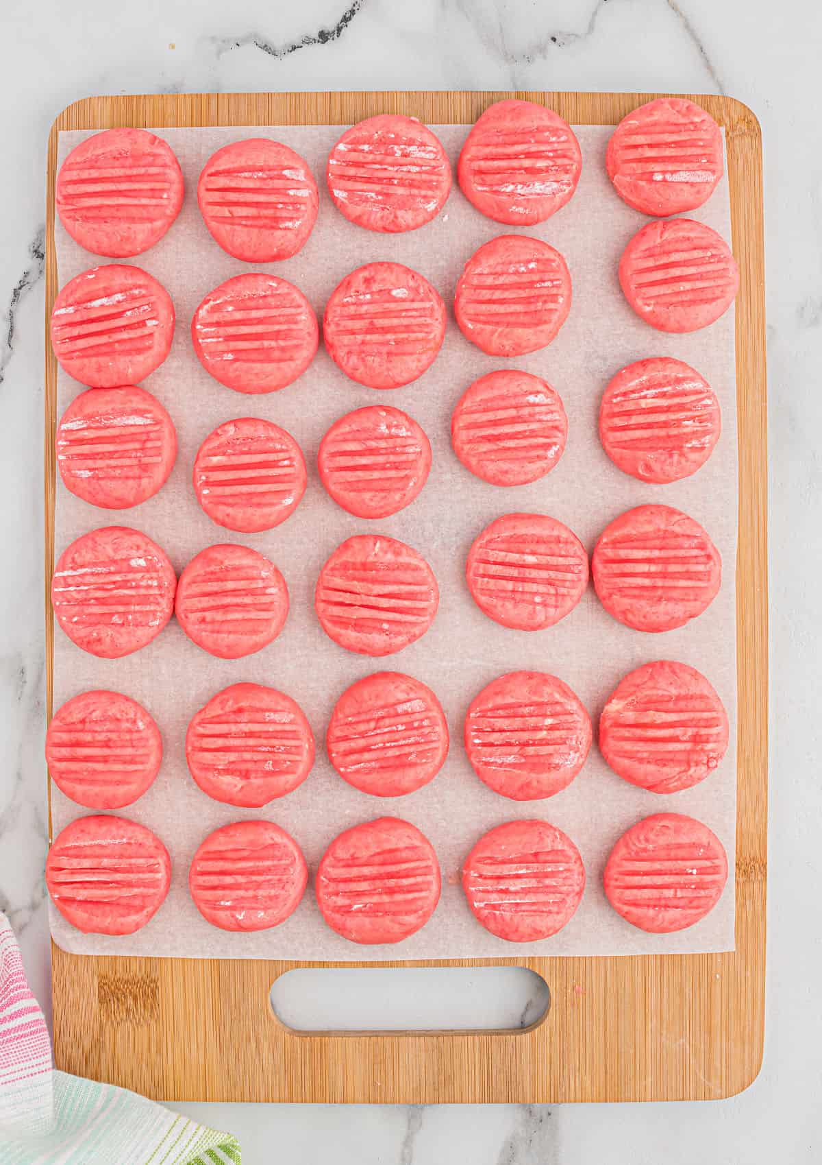 Strawberry mints setting on a parchment paper lined cutting board.
