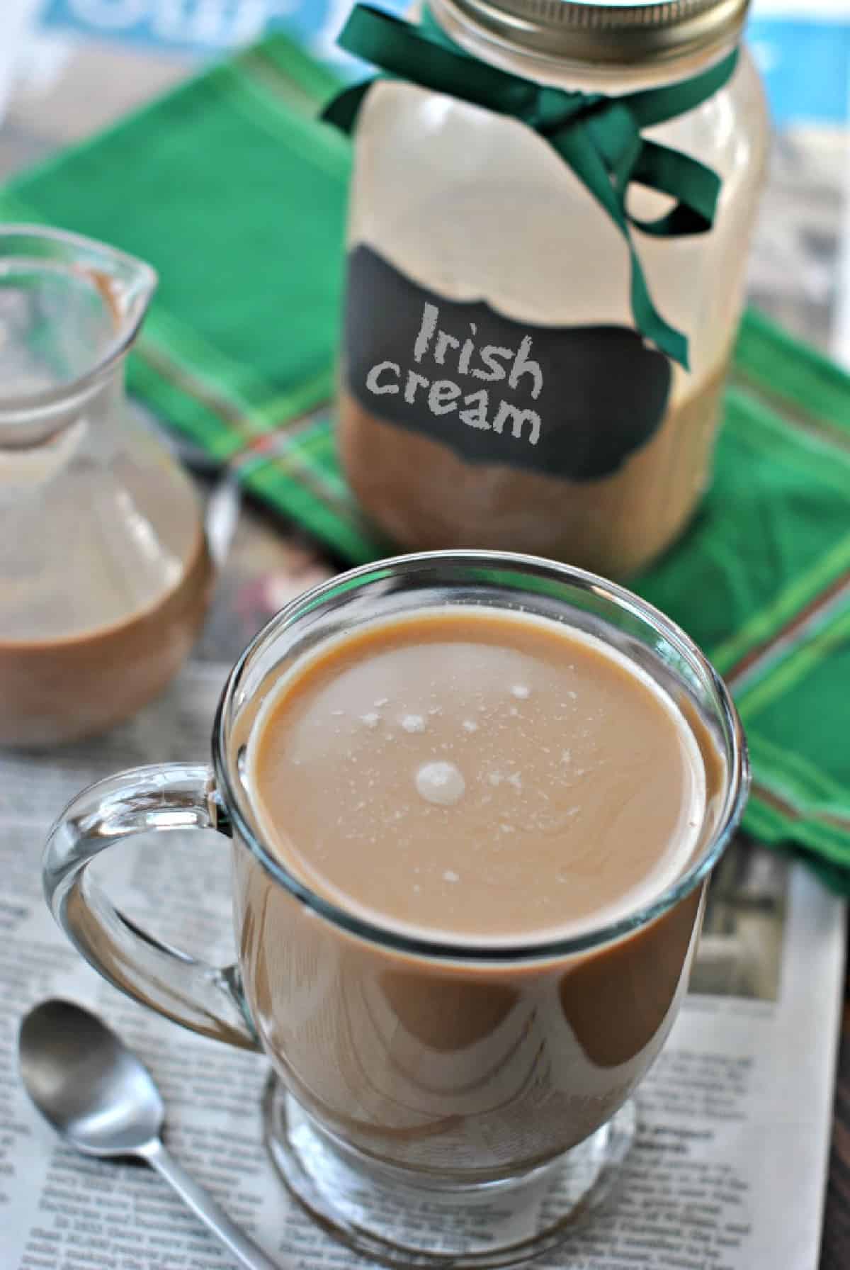 Irish cream coffee creamer in a mason jar with a mug of coffee.