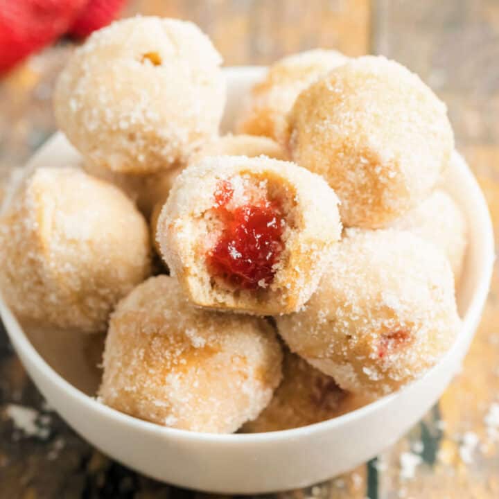 Raspberry preserves filled donut holes.