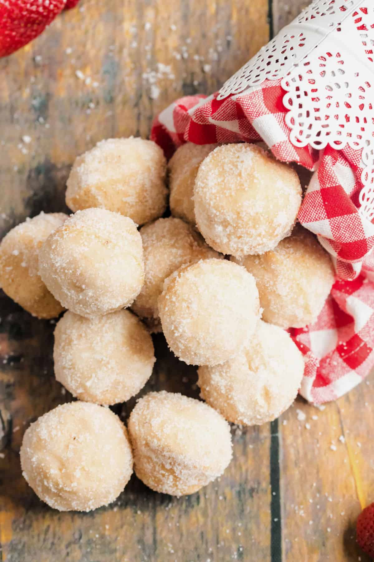 Jelly filled donut holes falling out of a bowl.