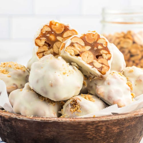 Love PayDay candy bars? Try making these PayDay truffles at home! Gooey caramel nut filling dipped in white chocolate.