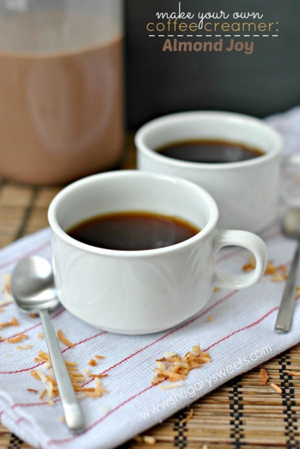 Two cups of black coffee with homemade almond joy creamer in a jar.