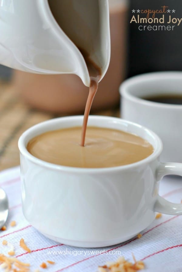 Homemade almond joy coffee creamer being poured into a mug of coffee.