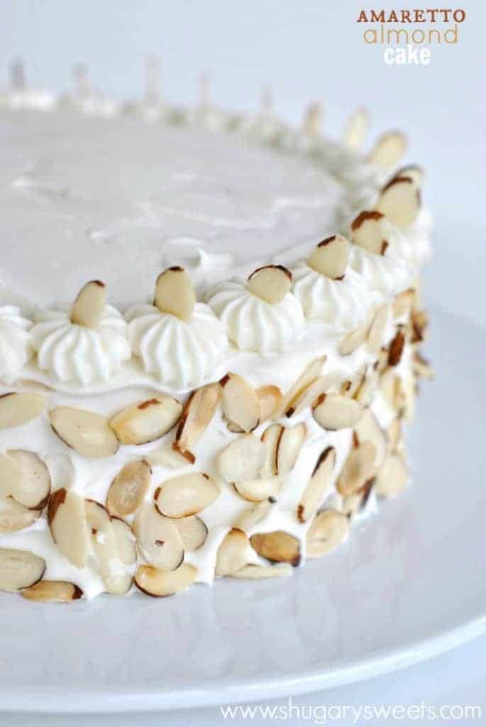 Perfect White Cake recipe topped with an Amaretto Cream Cheese frosting and toasted almonds. YUM!!!