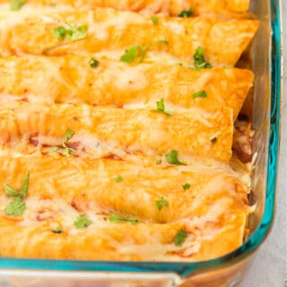 Vegetarian enchiladas in a clear glass baking dish.