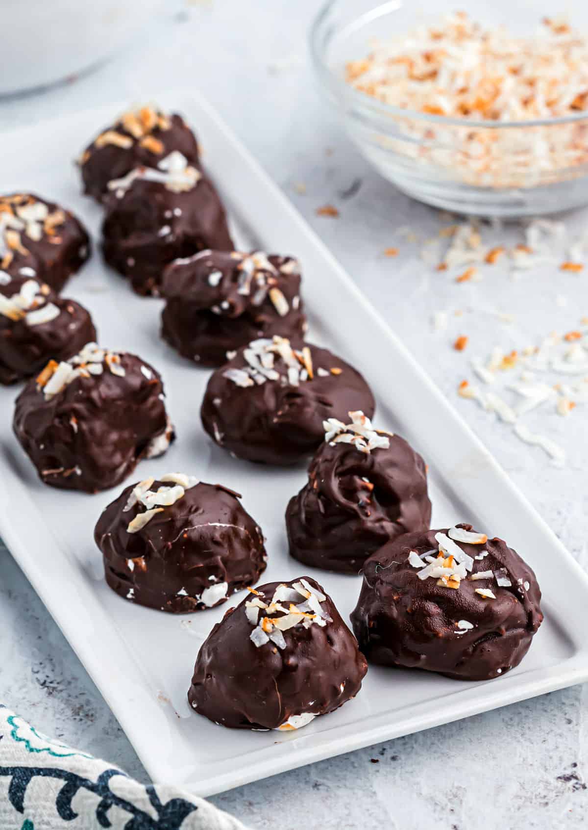 Coconut truffles served on a white platter.