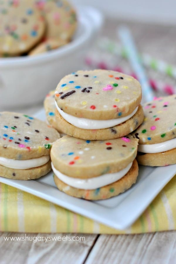 Stacked funfetti sandwich cookies on a plate.