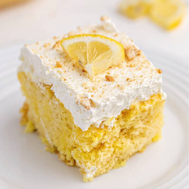 Slice of lemon cake with lemon curd and cool whip.