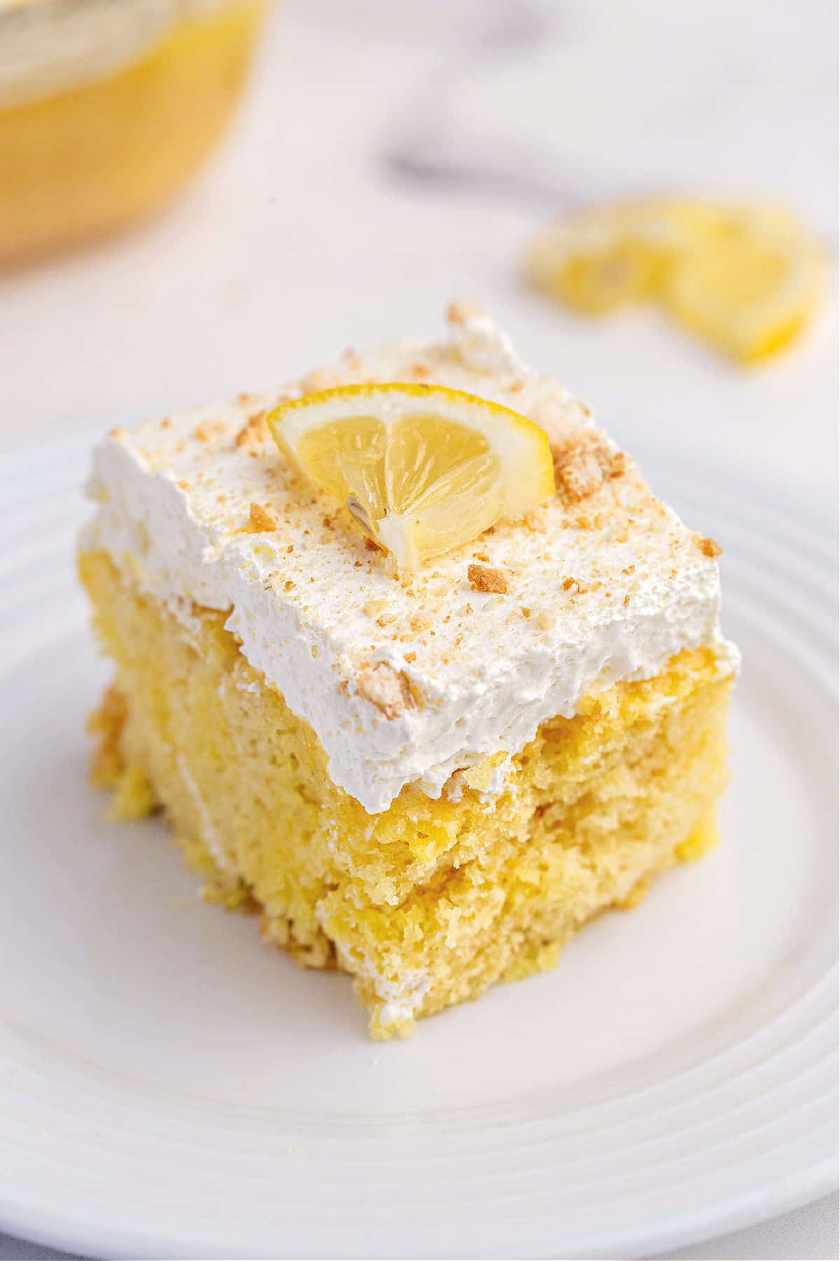 Lemon cake topped with lemon gelatin, cool whip, and nilla wafer crumbs.