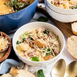 Flavorful Zuppa Toscana Soup tastes even better than the Olive Garden original! Italian sausage is simmered with spinach, bacon and fragrant herbs in a creamy broth.