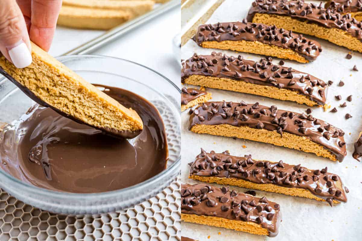 A hand dips a chocolate peanut butter biscotti into melted chocolate; chocolate-dipped biscotti with chocolate chips cool on parchment.