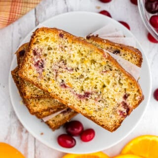 This glazed Cranberry Orange Bread has the perfect blend of sweet, tangy flavor! Bursting with juicy cranberries and orange zest, it's a moist quick bread that you'll love with your morning coffee.