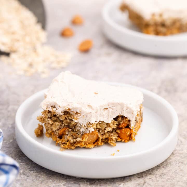 Oatmeal butterscotch cookie bar with frosting and one bite removed.