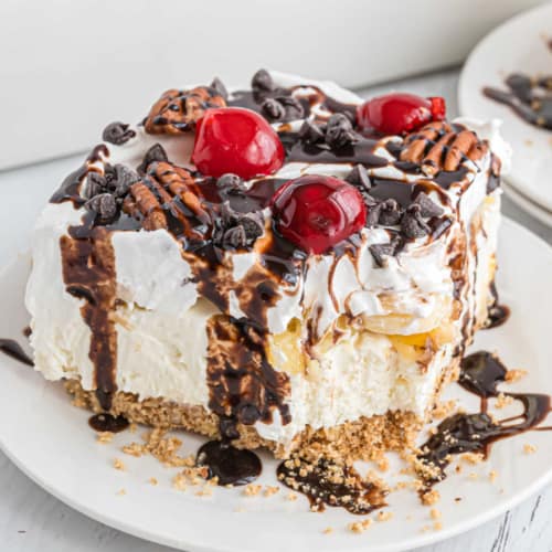 These No Bake Banana Split Cheesecake Bars just might be the best dessert. Delicious rich cheesecake with no oven needed, and topped with all the fruit, chocolate, and whipped cream!