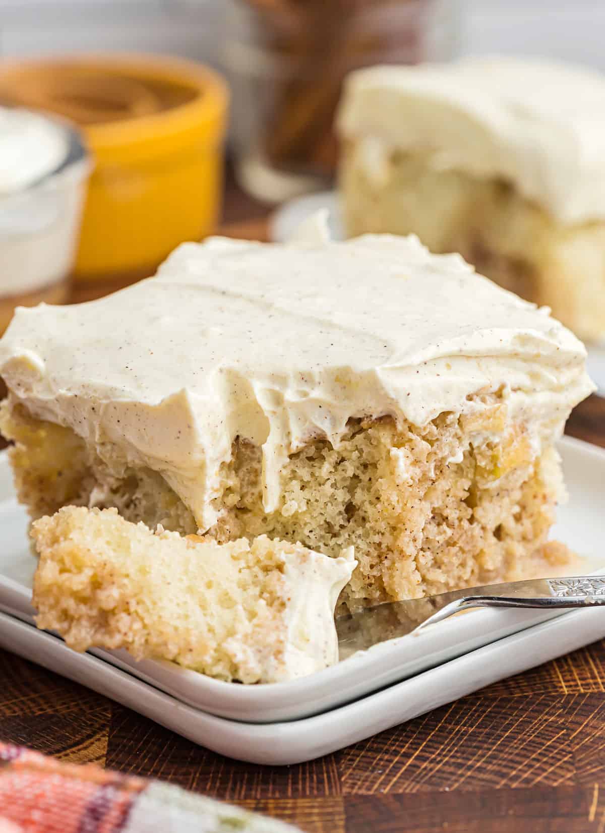 Fork taking a bite of apple cake.