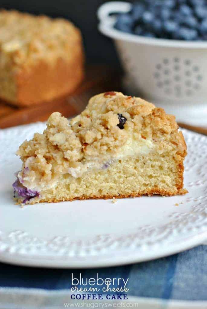 Coffee cake with layer of blueberries and cream cheese.
