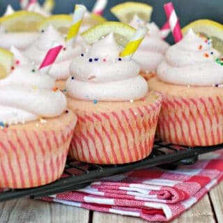 Pink lemonade cupcakes on wire cooling rack.