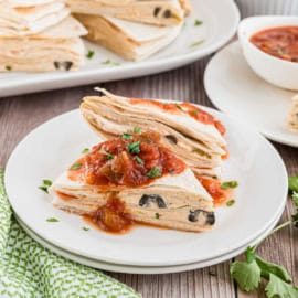 These Taco Tortilla Stacks have been made in our family for years! Assemble them ahead of time then serve them as a quick snack for a crowd. The cheesy layers and Mexican flavors make these tortilla stacks totally irresistible.